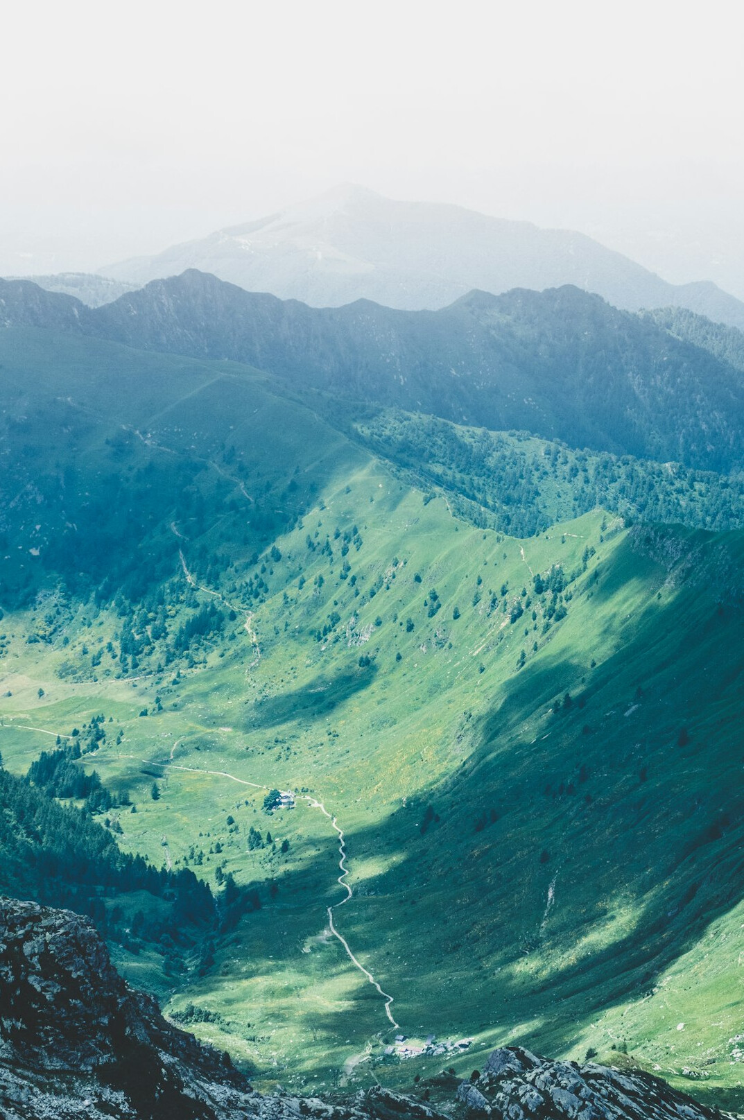 Green mountains covered in mist above a valley