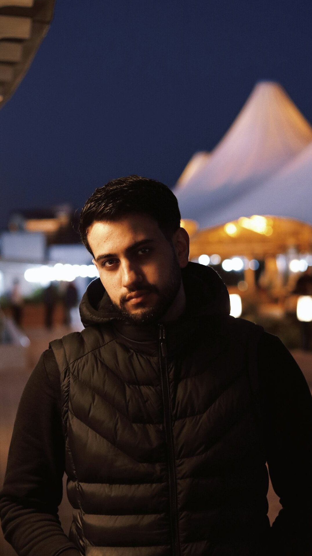 Portrait of a man in a dark jacket looking at the camera