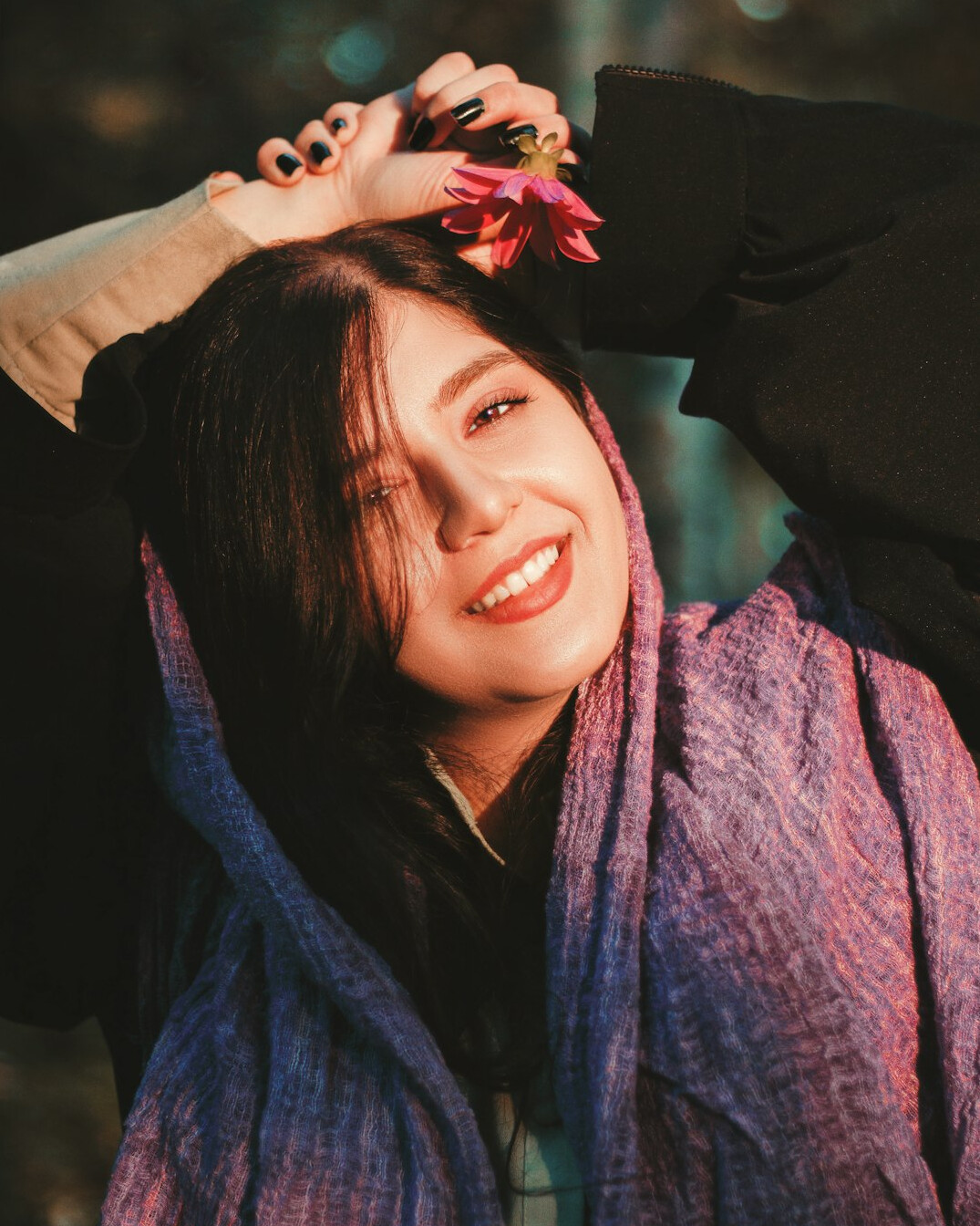 Portrait of a woman with dark hair smiling warmly