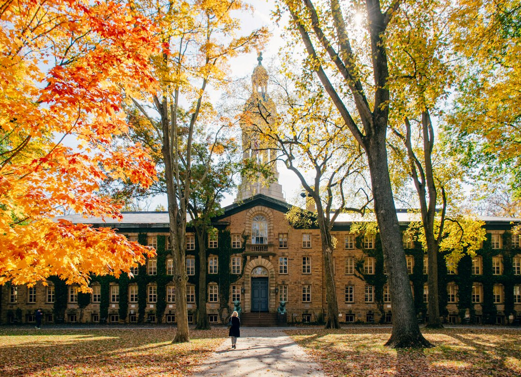 University campus building with trees and a stone entrance